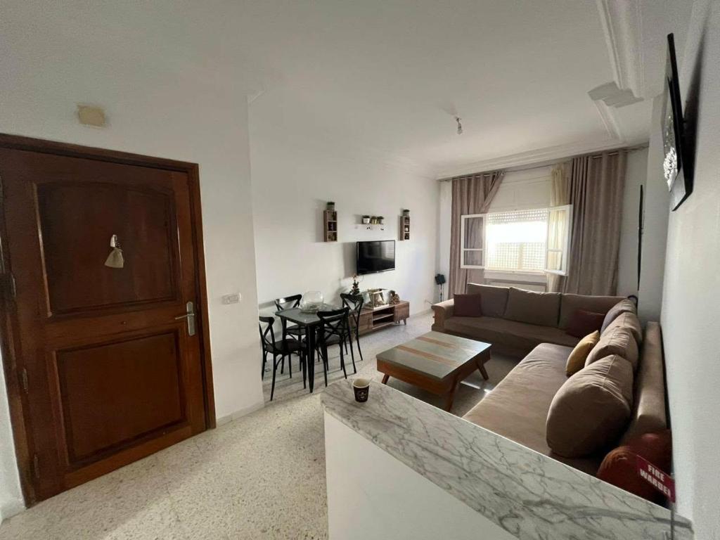 a living room with a couch and a table at La Marsa in El Aouina Station