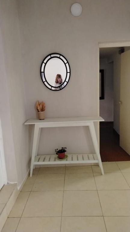a dog sitting on a shelf with a mirror at Magda in Resistencia
