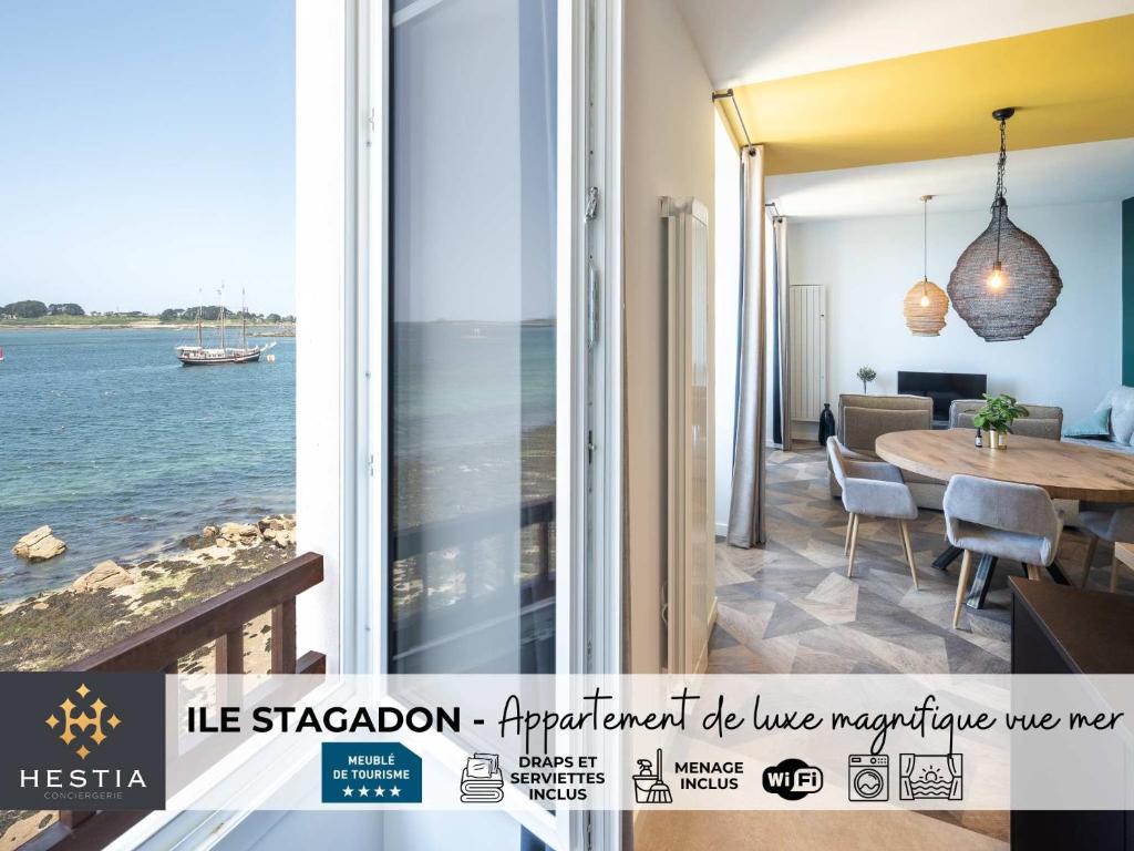 a dining room with a view of the ocean at ILE STAGADON - Appartement de luxe magnifique vue mer in Landéda