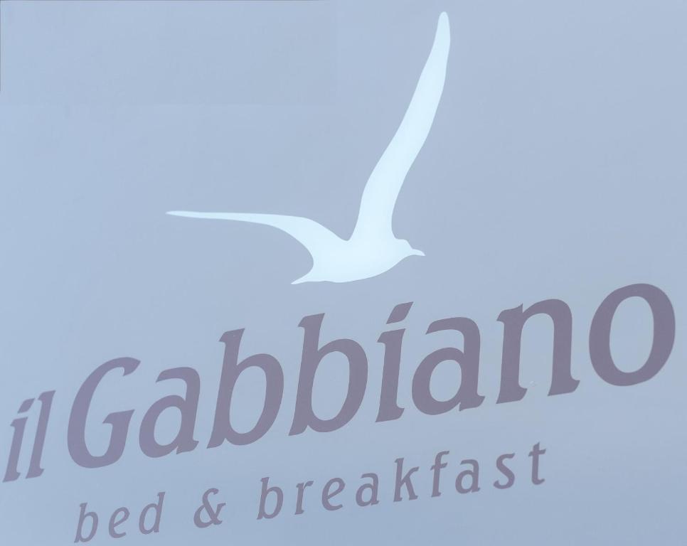 a white bird flying over the words al cabelloello bed and breakfast at Il Gabbiano rooms in Donnalucata