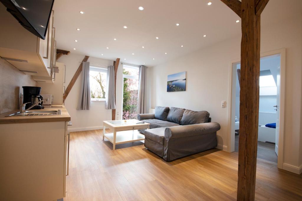 a living room with a couch and a table at Ferienwohnung BEA 3 in Rabenkirchen-Faulück
