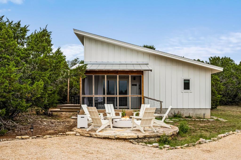 a group of chairs sitting in front of a house at Camp Jackalope - Outdoor Trails - Fire Pit - Views in Wimberley