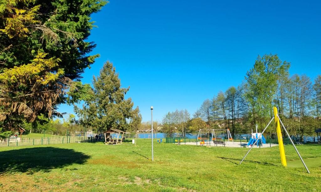an empty park with swings and a playground at Parc- Camping de Coullons in Coullons