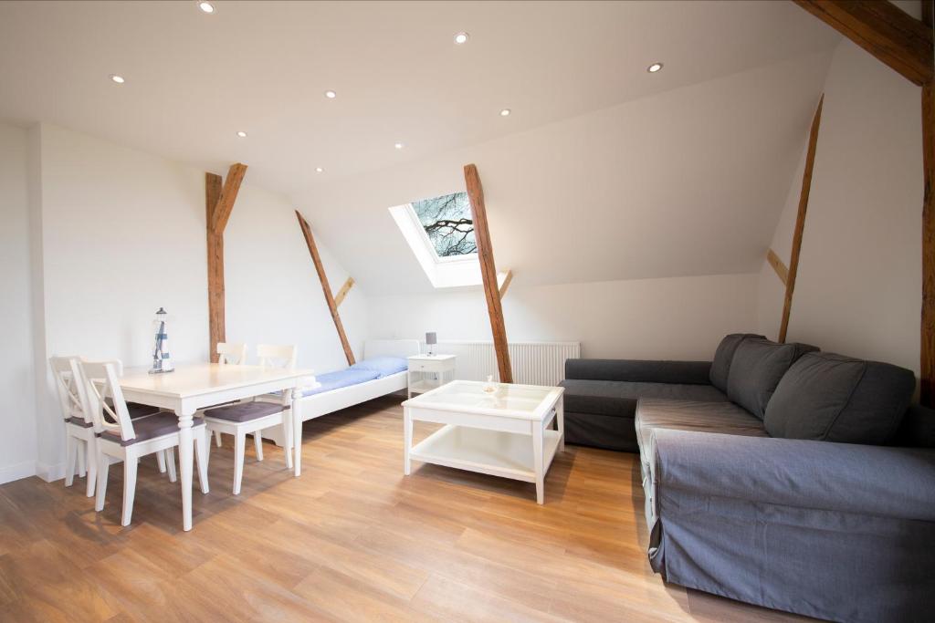 a living room with a couch and a table at Ferienwohnung BEA 2 in Rabenkirchen-Faulück