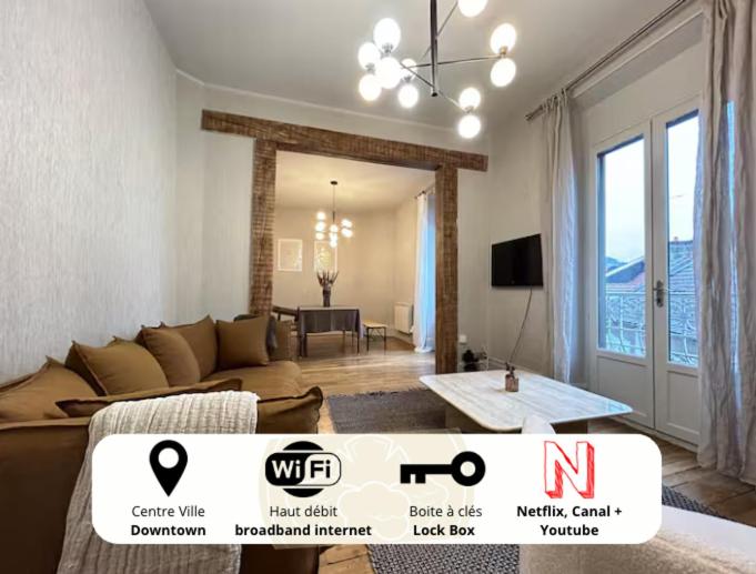 a living room with a couch and a table in a room at Nuit D'or - Vintage 97 - Séjour & Pro in Épernay