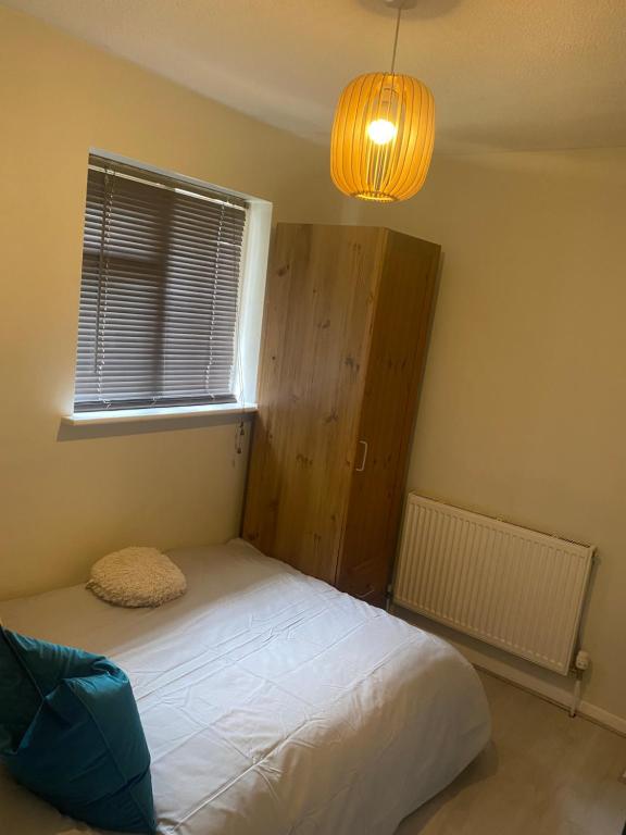 a small bedroom with a bed and a window at Private room with private bathroom in Hackington