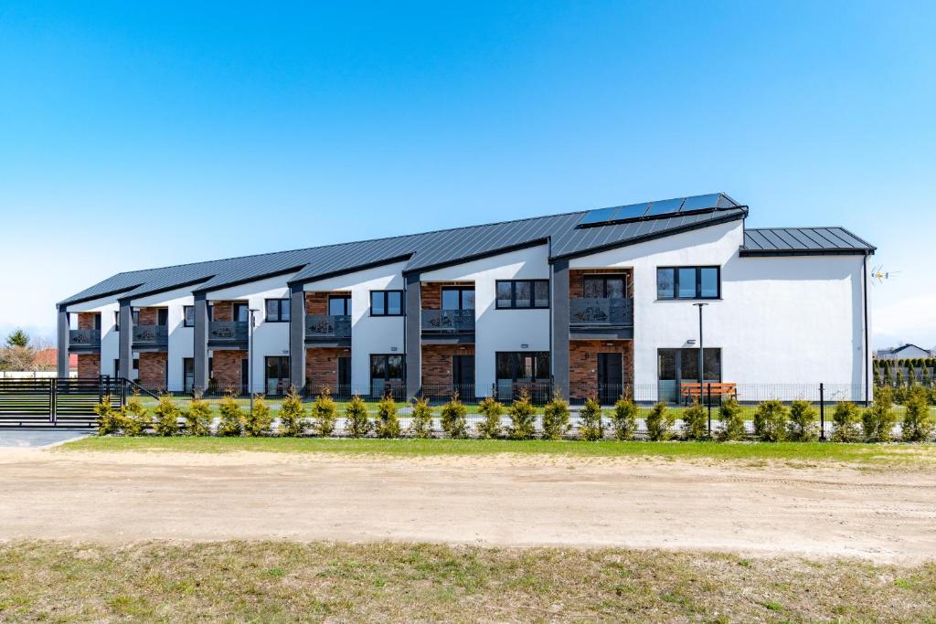 an image of a building with solar panels on it at Morski Resort in Ustka