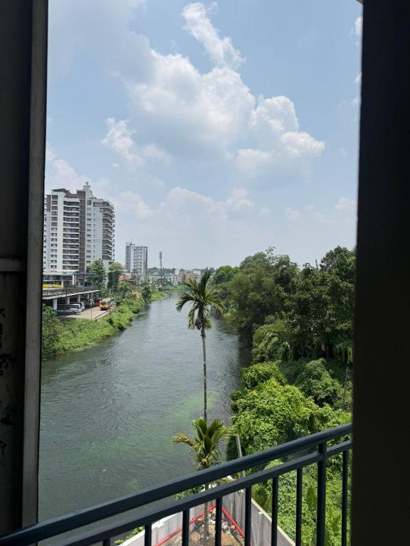 a view of a river from a balcony at Staio Rooms in Thodupuzha