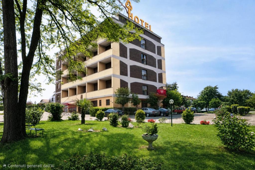 a building with a park in front of it at Hotel Europa Milano in Rosate
