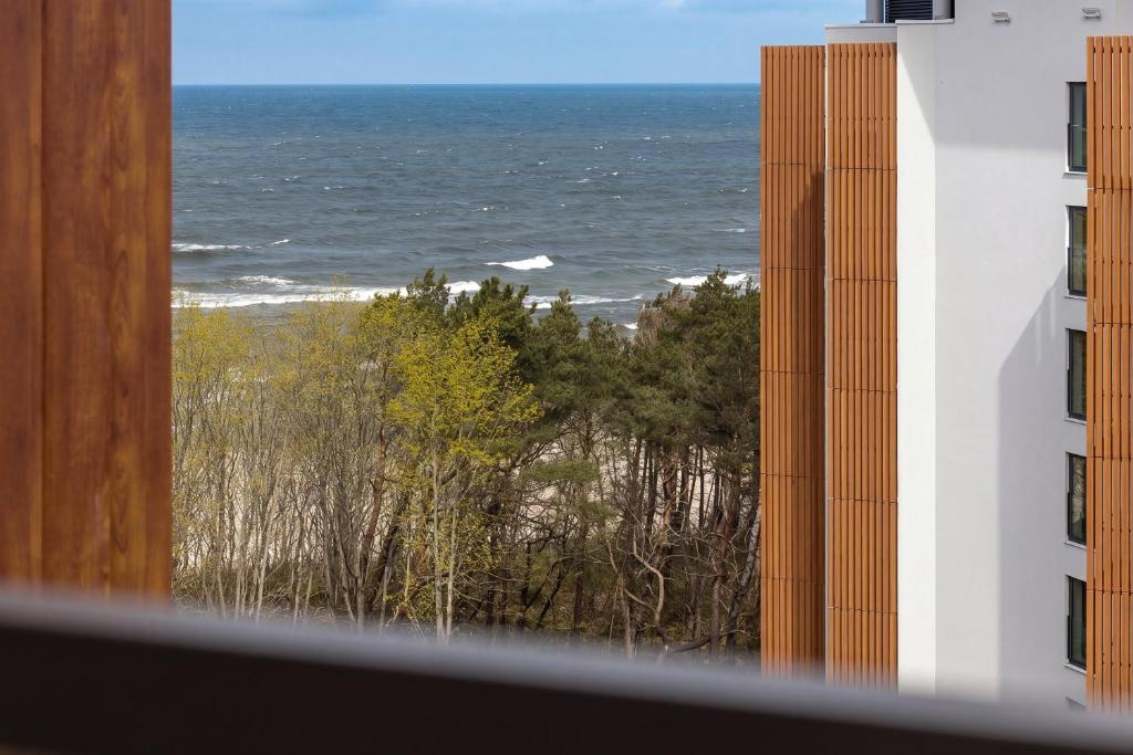 a view of the ocean from a building at PINEA Apartamenty in Pobierowo