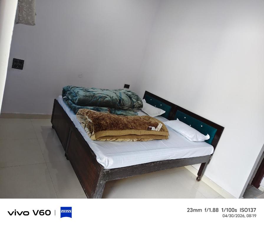 a bed with two pillows on top of it at Shaaneshwar Mahadev Hotel & Restaurant in Phata