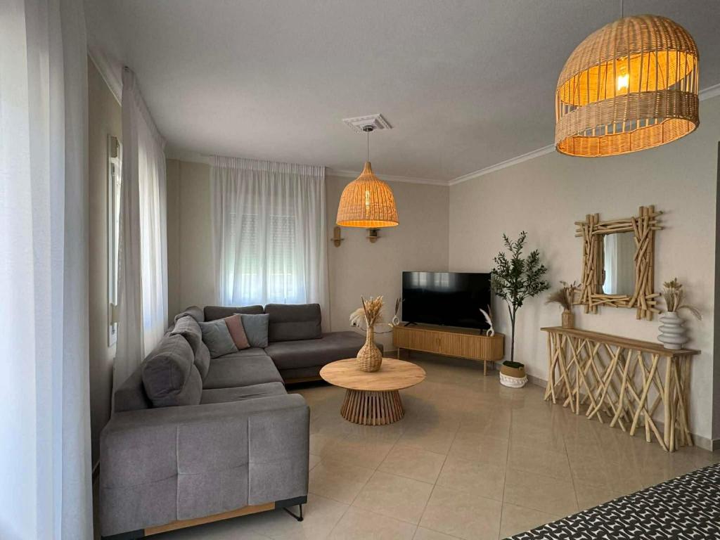 a living room with a couch and a table at King George in Korinos