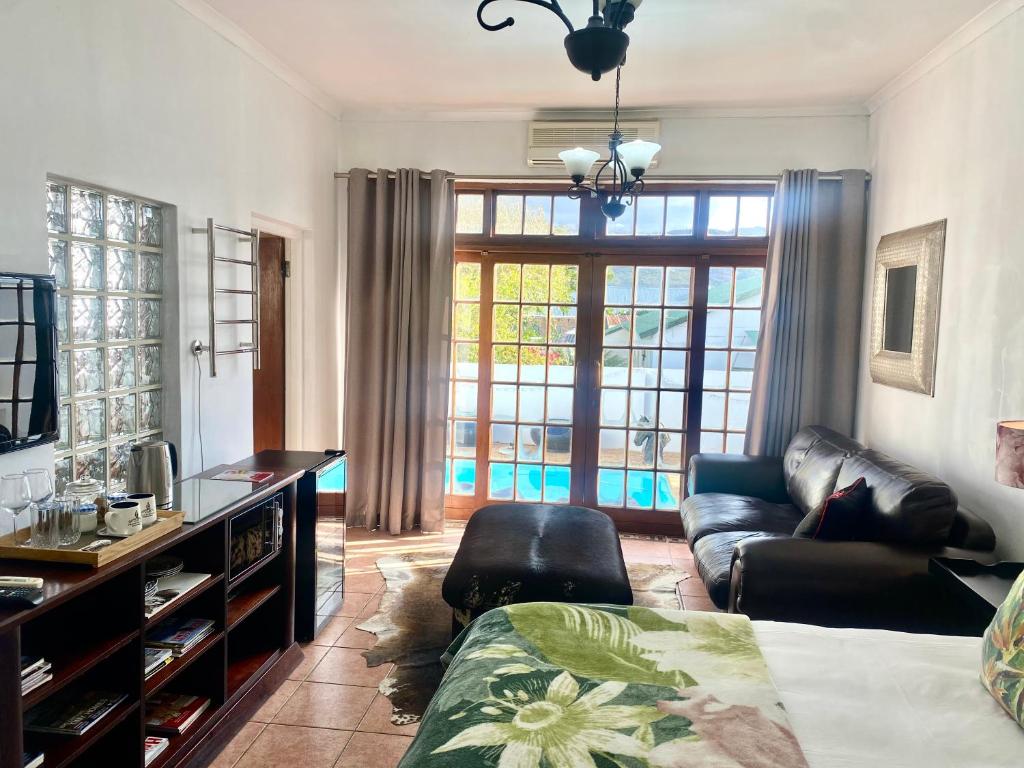 a living room with a bed and a couch at Franschhoek Mountain Escape in Franschhoek