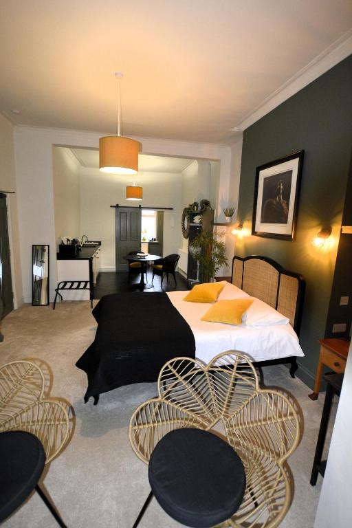 a bedroom with a bed and tables and chairs at Crescent House in Plymouth
