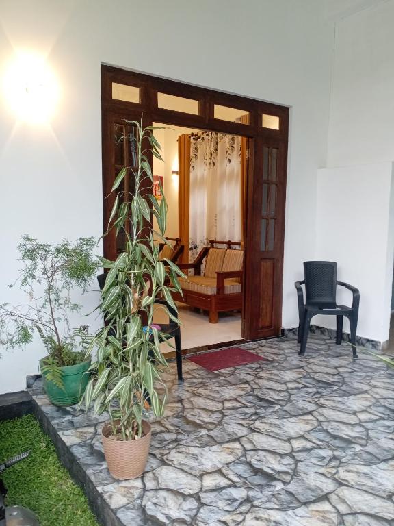 a door to a room with a couch and some plants at Hidden Pearl in Kandy