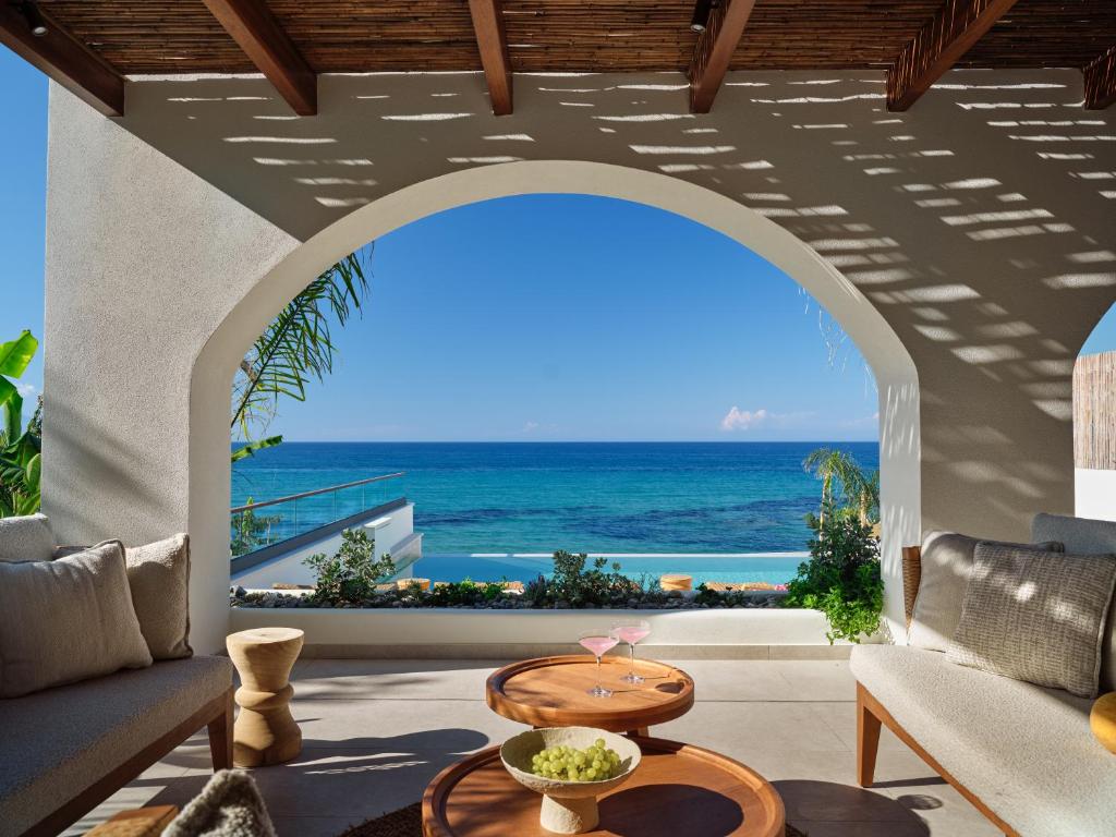 a living room with a view of the ocean at Oriana, Beachfront villa, few steps from the Ionian sea in Argassi