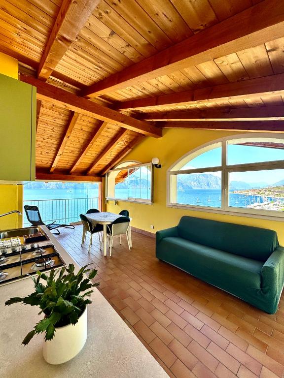 a living room with a green couch and a table at Monja Camping Village in Brenzone sul Garda