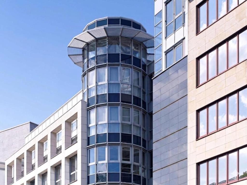 a tall glass building with a spiral at Sunday Hotel Dortmund City in Dortmund