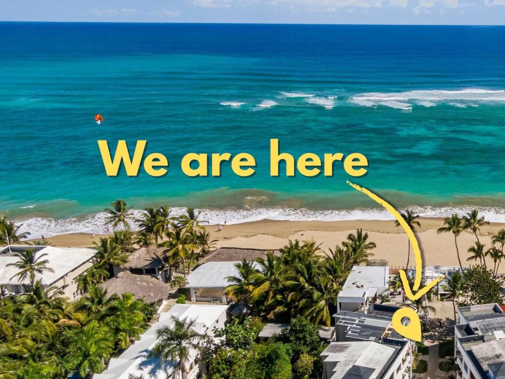 an image of a beach with the words we are here at Condo Cabrinha - Kite Beach Cabarete in Cabarete