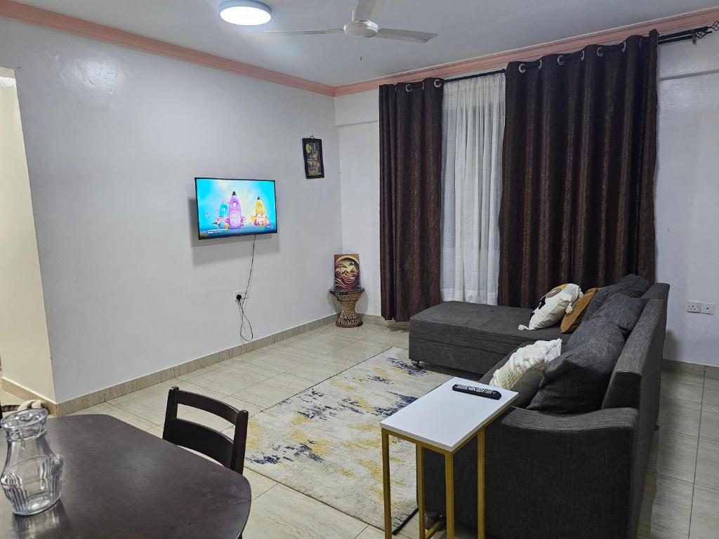 a living room with a couch and a table at Kim'sPlace in Mombasa