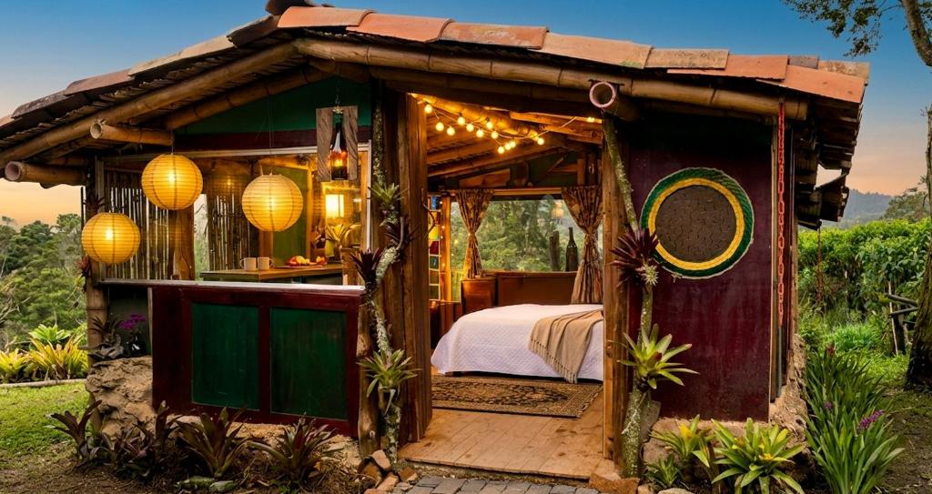 a small house with a bed and lights at Aldea Victoria EcoRefugio in Medellín