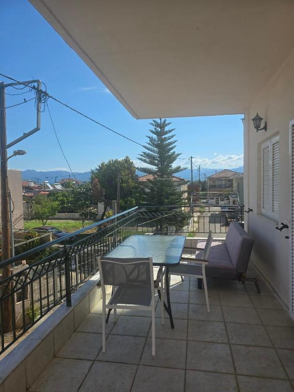 a patio with a table and chairs on a balcony at Nature & Sea Paradise in Analipsi in Análipsis