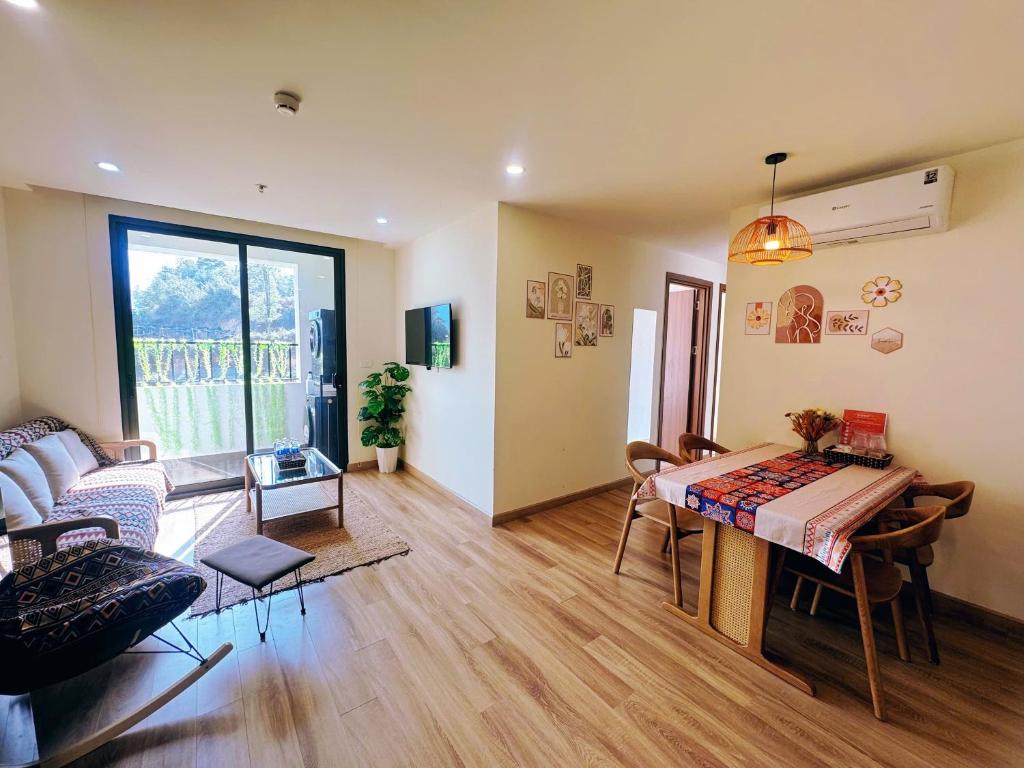 a living room with a table and a couch at Rose Home in Lao Cai