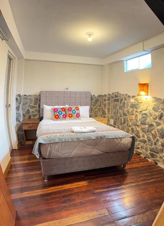 a bedroom with a large bed in a room at intikilla hostal in Ollantaytambo