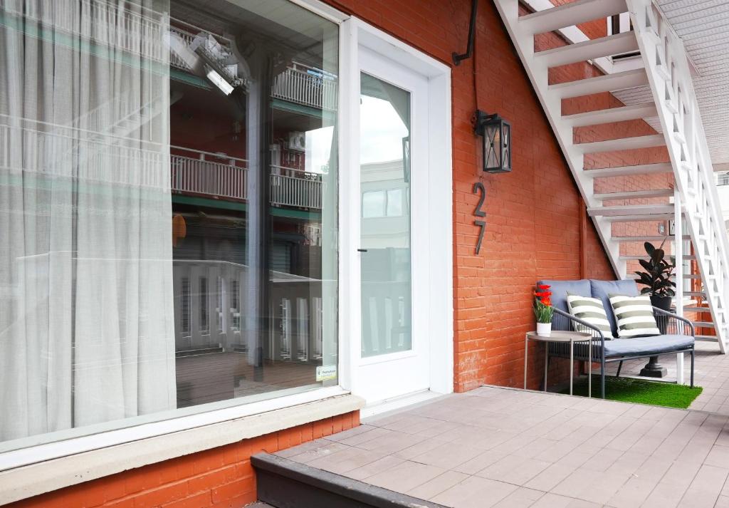 a sliding glass door on a house with a patio at Studio 27 in Magog-Orford