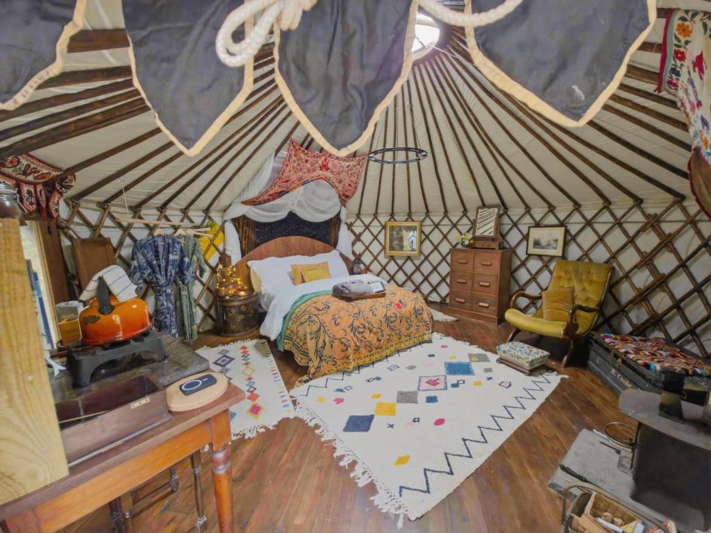 a bedroom with a bed in a yurt at Esk Yurt in Drummelzier