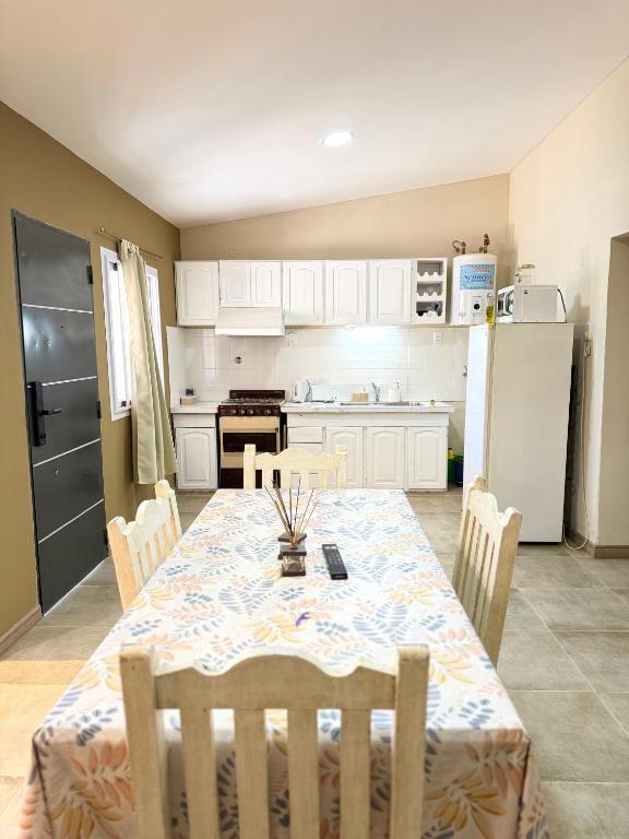 a kitchen with a table with chairs and a refrigerator at Deluxe Nueva Casa in General Alvear