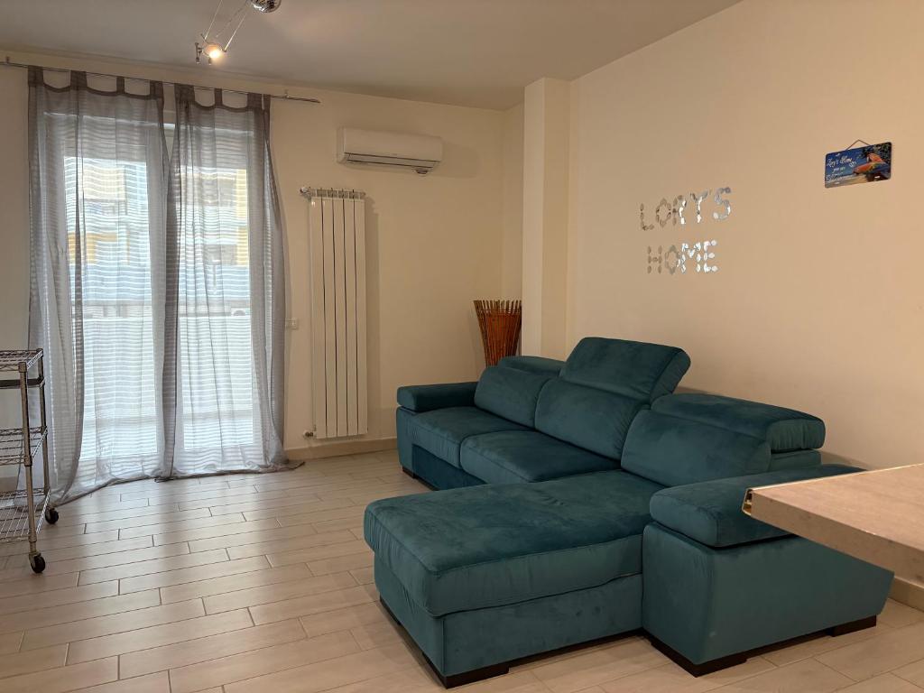 a living room with a couch and a table at Bari Lory’s Home in Bari