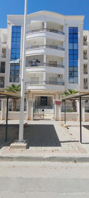 a large white building with a lot of windows at Appartement 24 in Sousse
