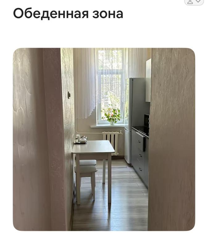 a small kitchen with a table and a window at Fly Apart in (( Turksib ))