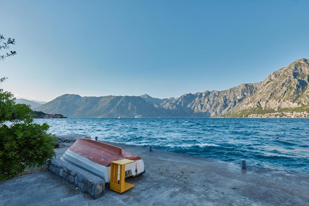 a bed on the shore of a body of water at Aura Maris Apartment in Kotor