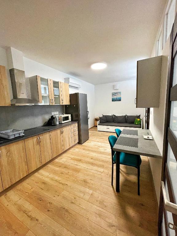 a kitchen and dining room with a table and chairs at Apartmán Bytča in Bytca