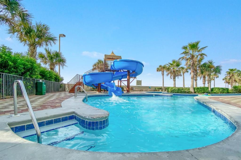 a water slide in a pool at a resort at Phoenix West 2207 Upscale Luxury Updated Beachfront Waterslide-Lazy River in Orange Beach