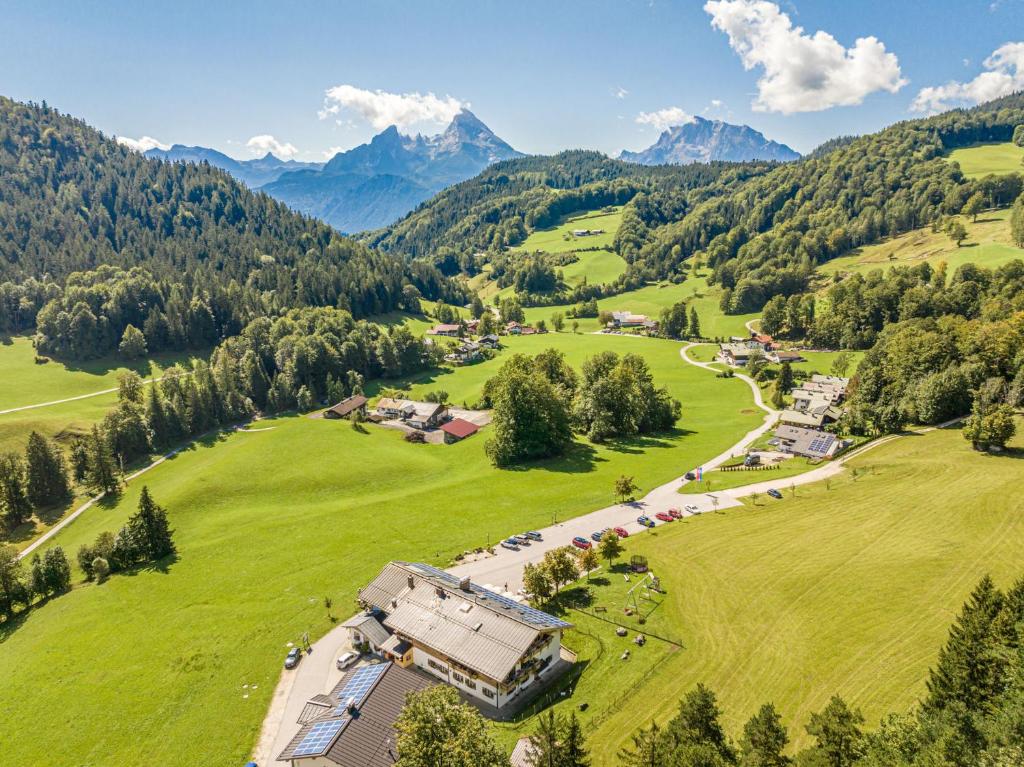 an aerial view of a farm with mountains in the background at Gasthof-Ferienwohnungen Dürrlehen in Berchtesgaden