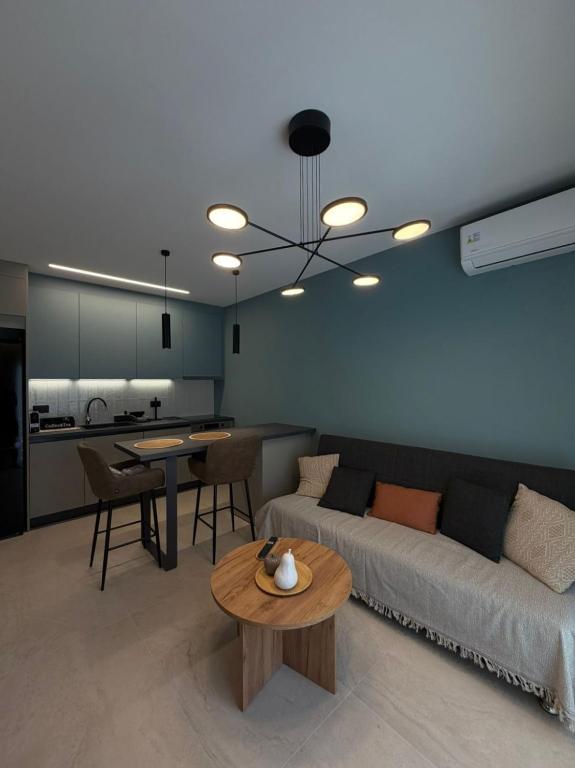 a living room with a couch and a table at Elea Living Chios in Chios