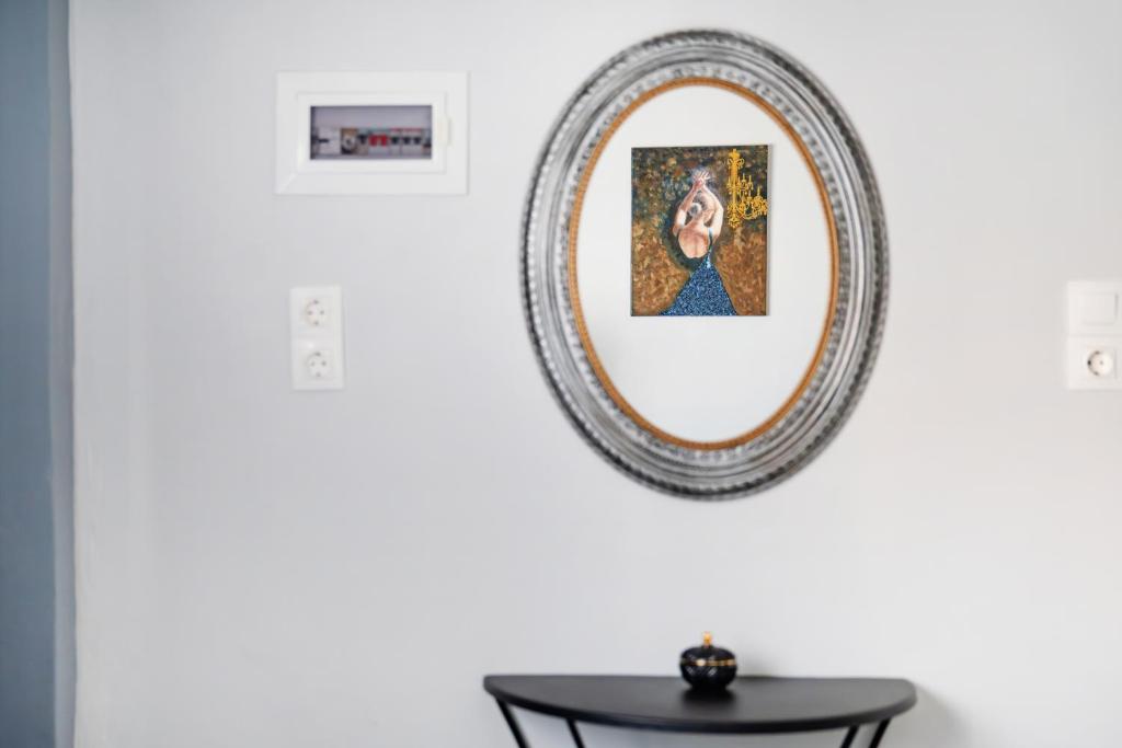a mirror hanging on a wall with a table at Design studio Two in Palekastron