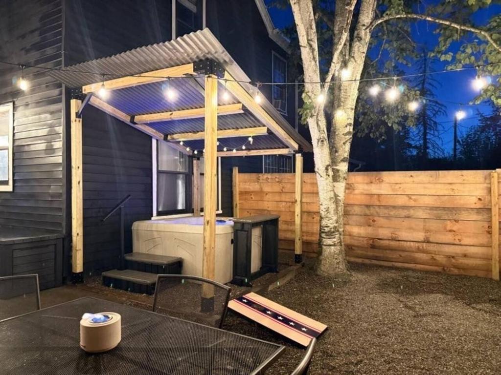 a patio with a grill and a table in front of a building at 2 Fun Homes in Hudson
