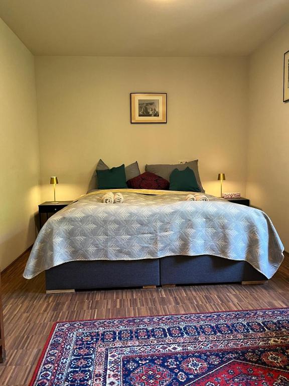 a bedroom with a large bed and a rug at Villa Pdorf in Perchtoldsdorf