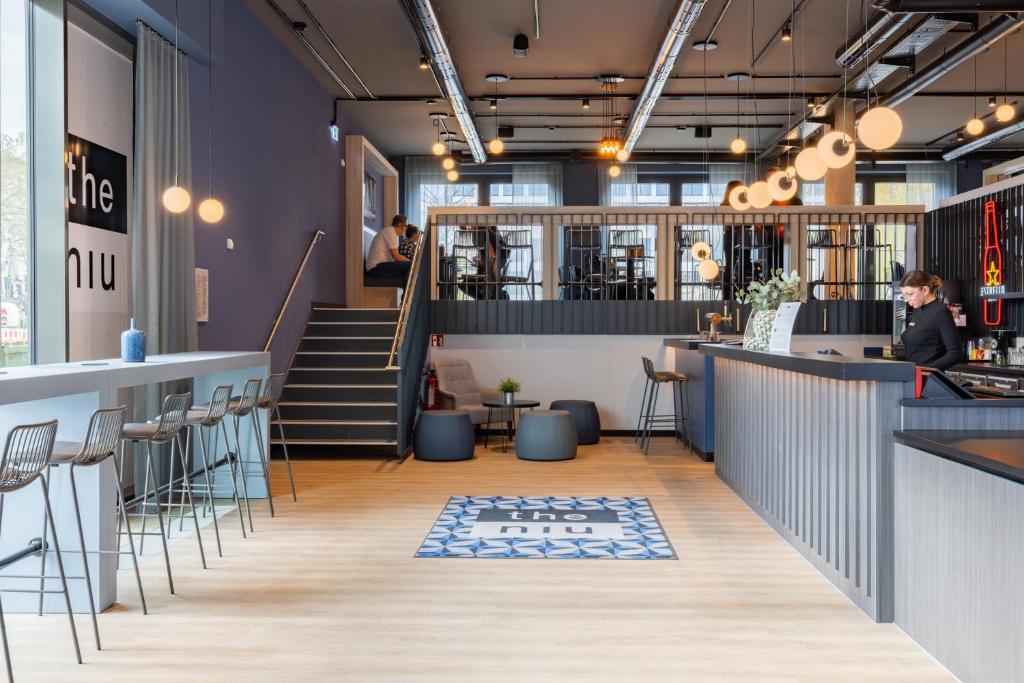 a view of the lobby of a restaurant with a bar at Holiday Inn - the niu, Quay Hamburg Harburg by IHG in Hamburg