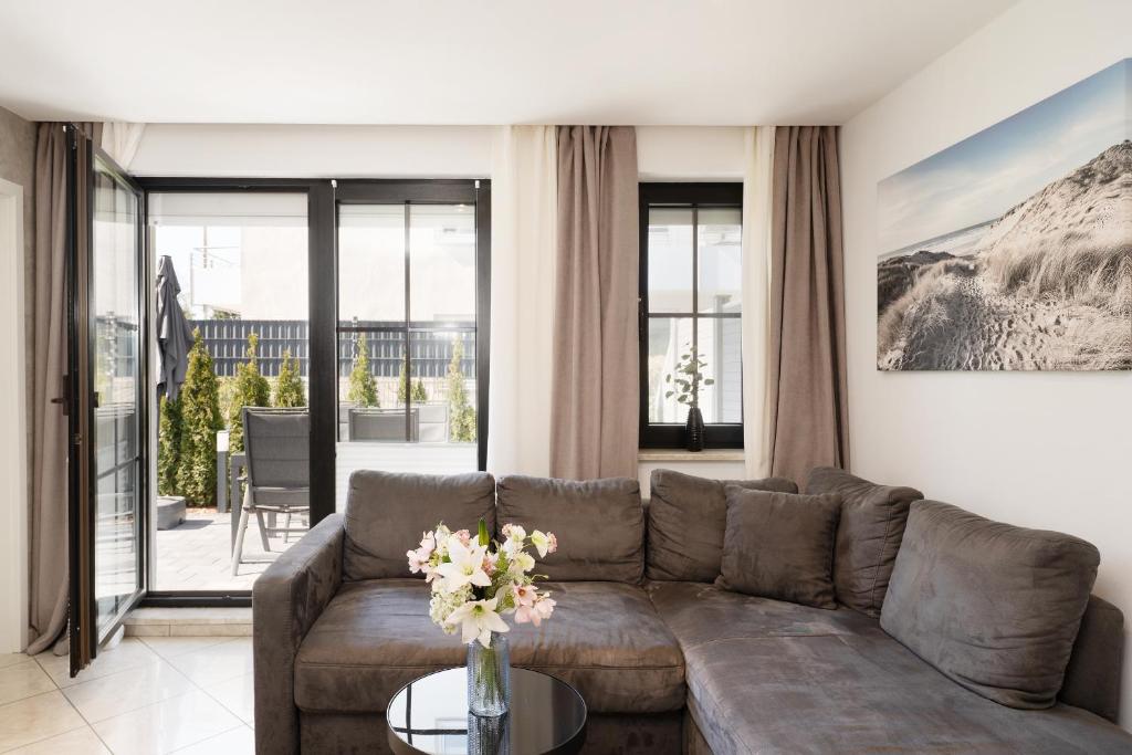 a living room with a couch and a table at Haus Titania Wohnung 2 in Grömitz