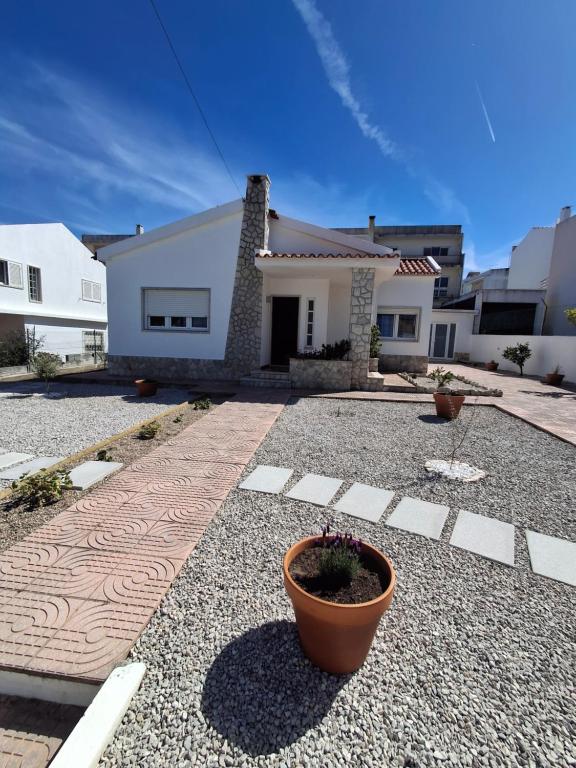 a house with a potted plant in front of it at Casa R in Sesimbra