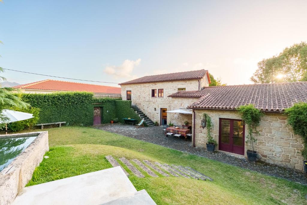 a backyard of a house with a yard at Casa Justininho in Ponte de Lima