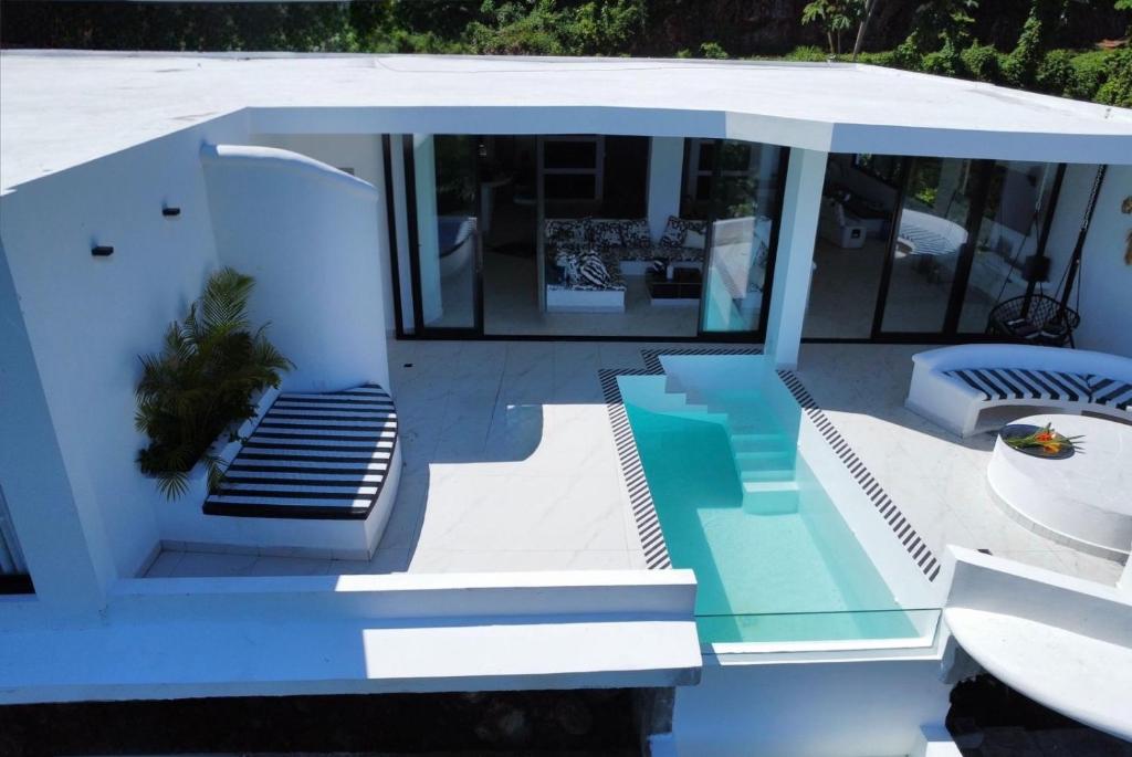 a house with a swimming pool on a boat at Villa Blanca only accessible by 4x4 vehicle in El Valle