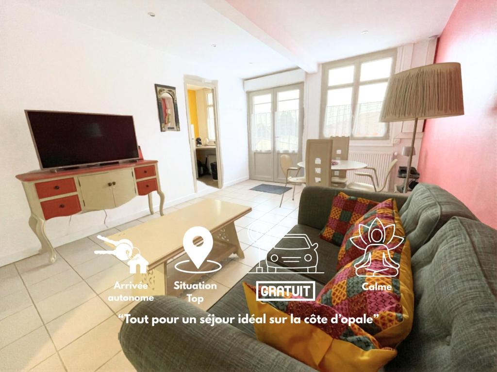 a living room with a couch and a table at Sérendipity in Marquise