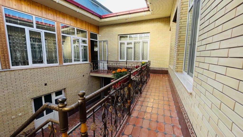a balcony of a house with flowers on it at Daniel SAMARKAND in Samarkand