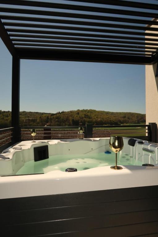 a bath tub in a room with a window at Design-Villa mit privatem Whirlpool&Naturblick in Wellheim
